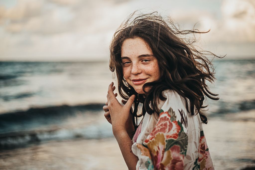 teenager on the beach, windy hair