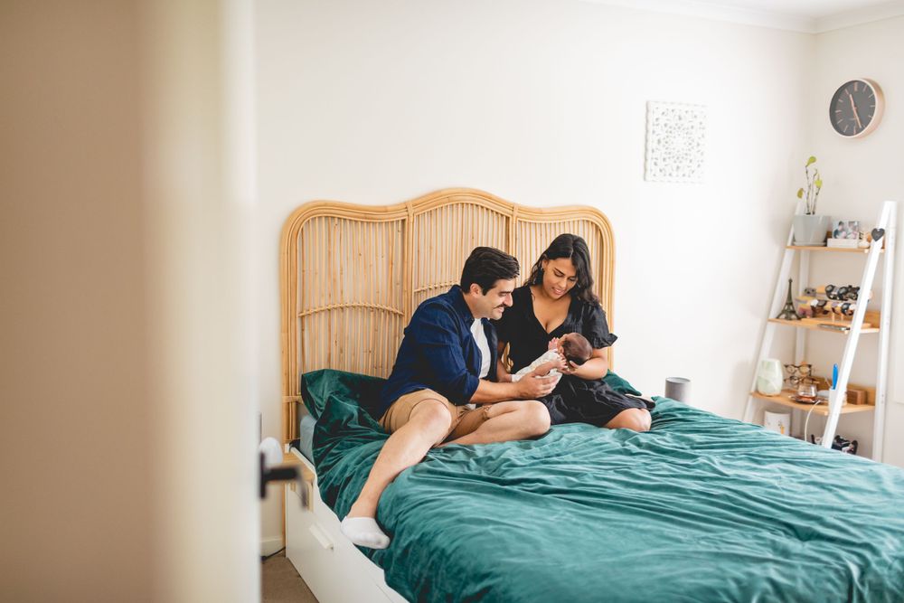 Cozy bedroom scene with rattan headboard and teal bedding.