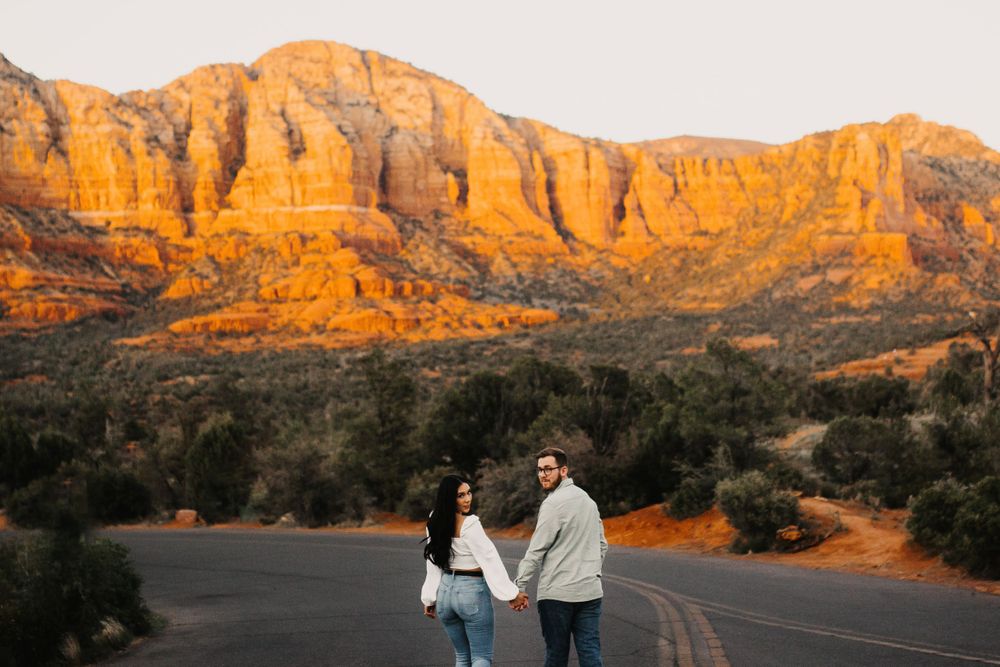 Majestic red rock formations in Sedona cast long shadows during sunset.