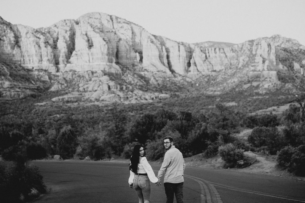 Black and white landscape of dramatic desert cliffs and winding road.