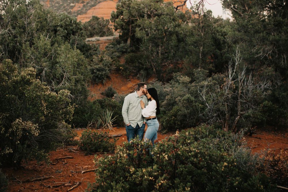 Romantic desert photoshoot with dramatic red rock backdrop.