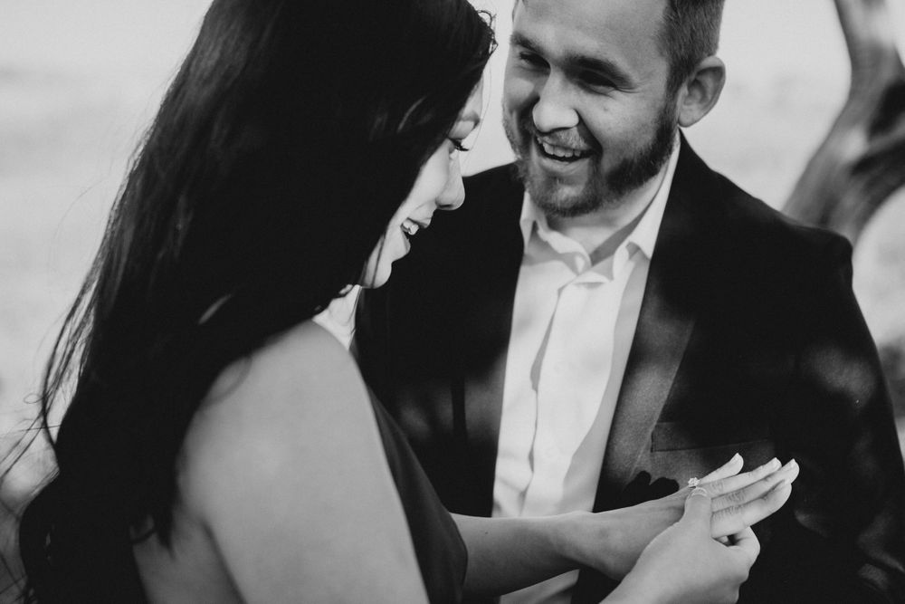 Black and white photos capture genuine emotions during an outdoor proposal moment.
