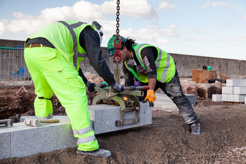 Construction photograph of Construction workers laying kerb