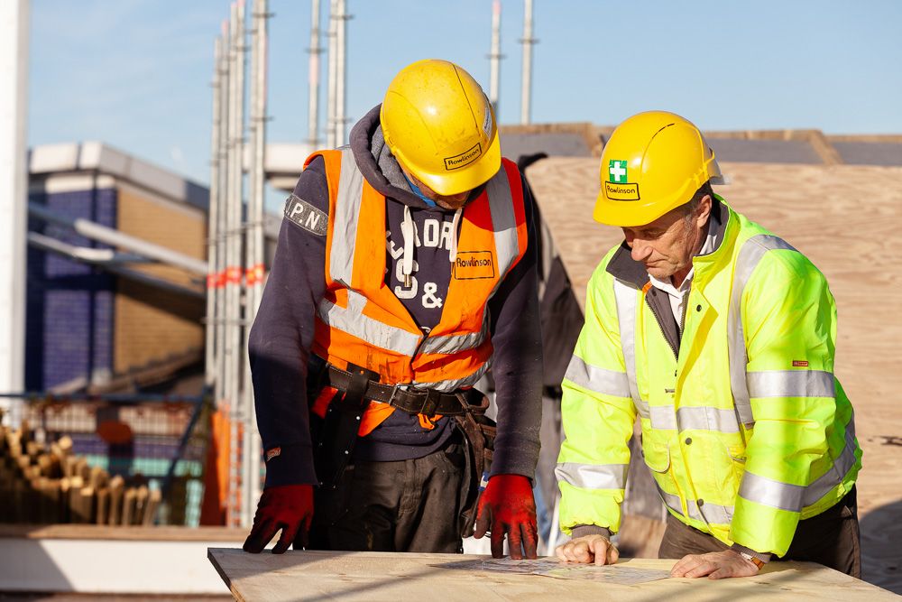 Construction photograph of Construction workers discussing plans