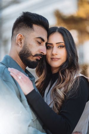 A romantic close-up portrait of a couple sharing an intimate moment outdoors.
