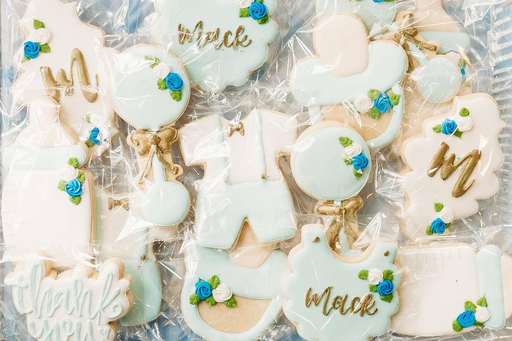 Delicate pastel cookies decorated with blue flowers and gold lettering for a baby shower celebration in the Hudson Valley,NY.