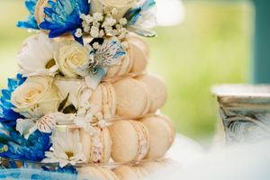 Elegant macaron arrangement decorated with cream roses and vibrant blue flowers in the Hudson Valley,NY.