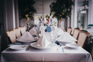 Elegant table setting with white linens and folded napkins for a formal event.