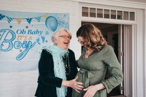 A heartwarming moment shared at a baby shower with blue decorations.