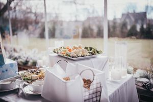 An elegantly set buffet table with appetizers and glassware for a special occasion.