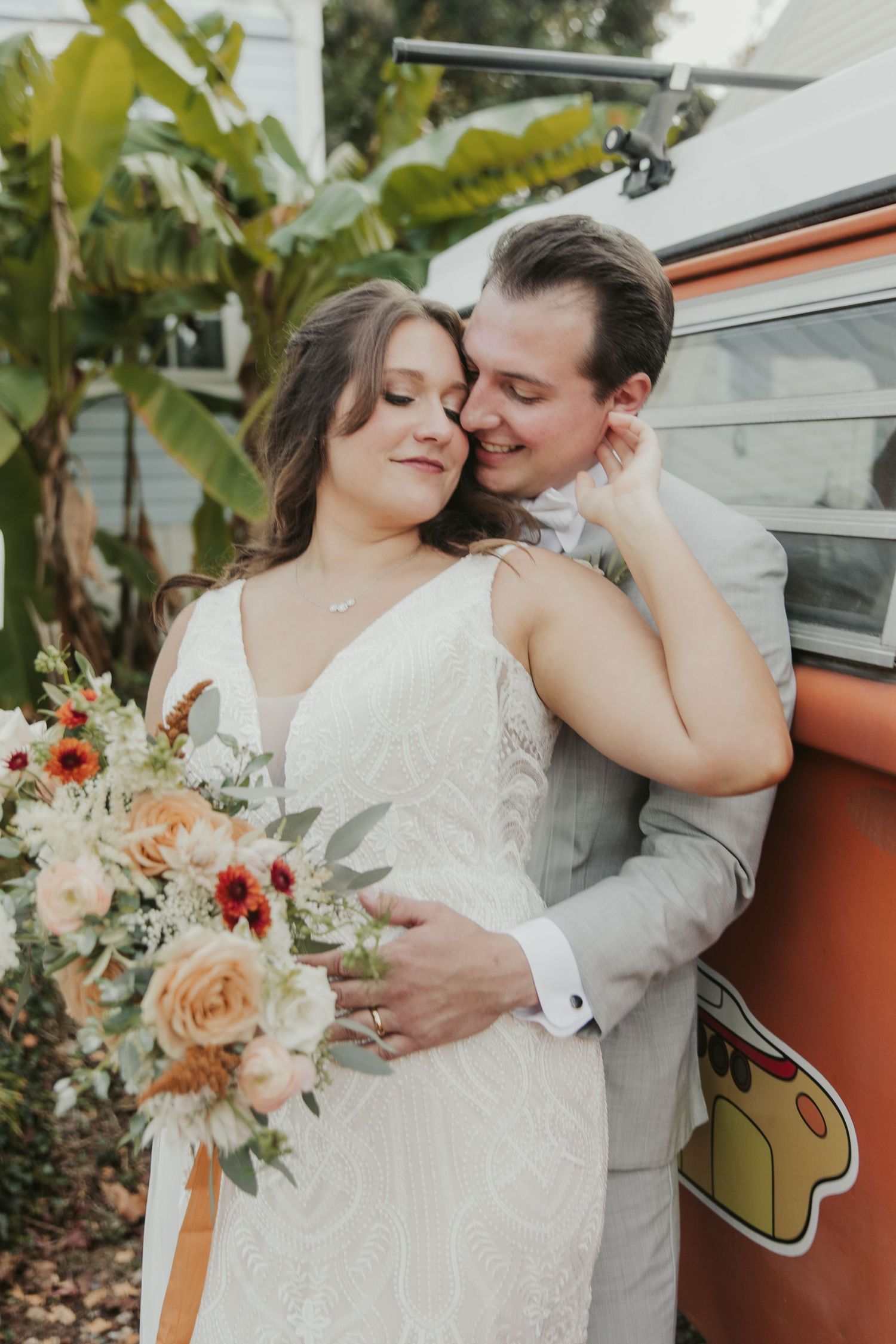 Intimate wedding portraits with vintage car and pastel floral bouquet.