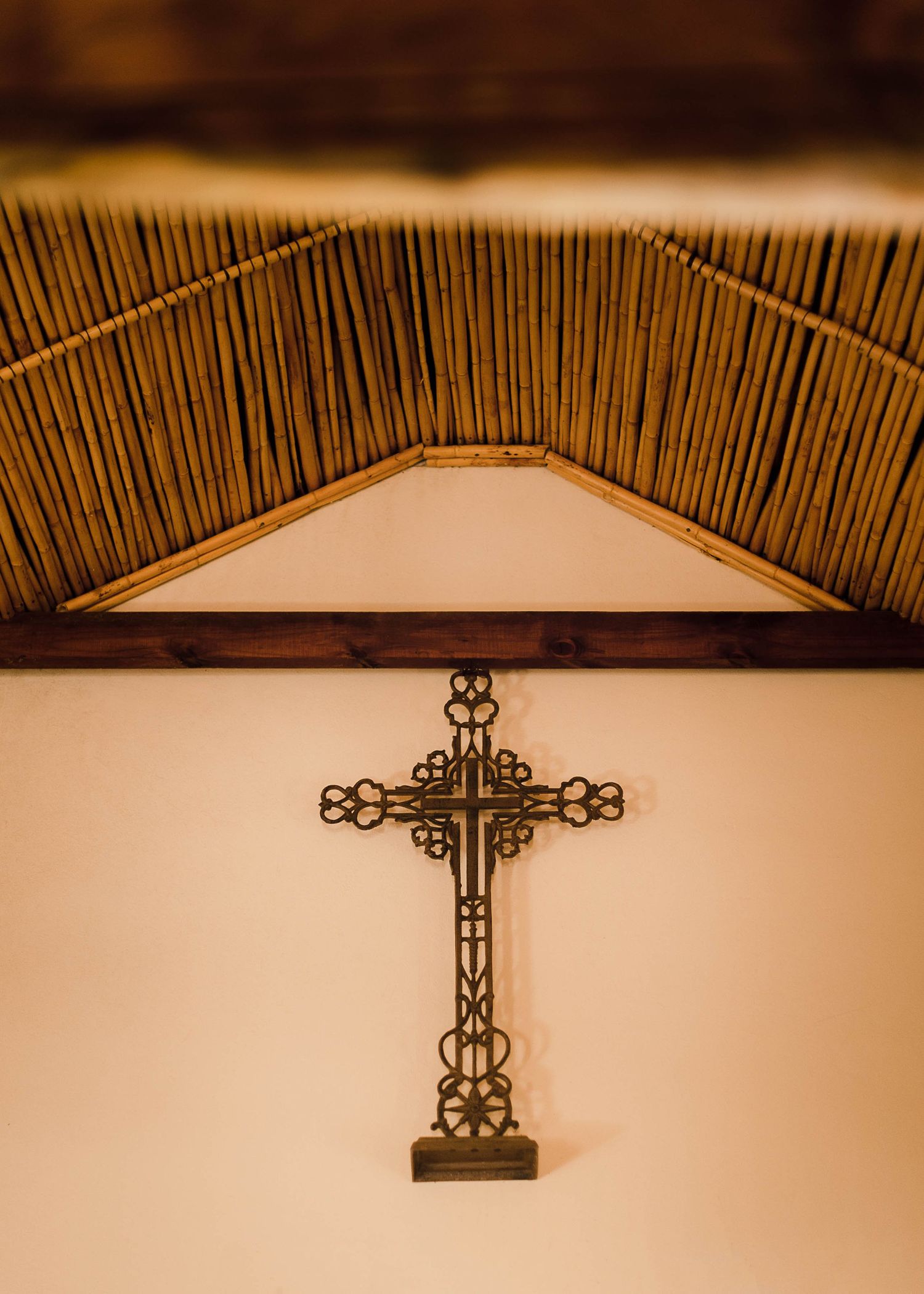 an ornate metal cross hanging the small historic chapel
