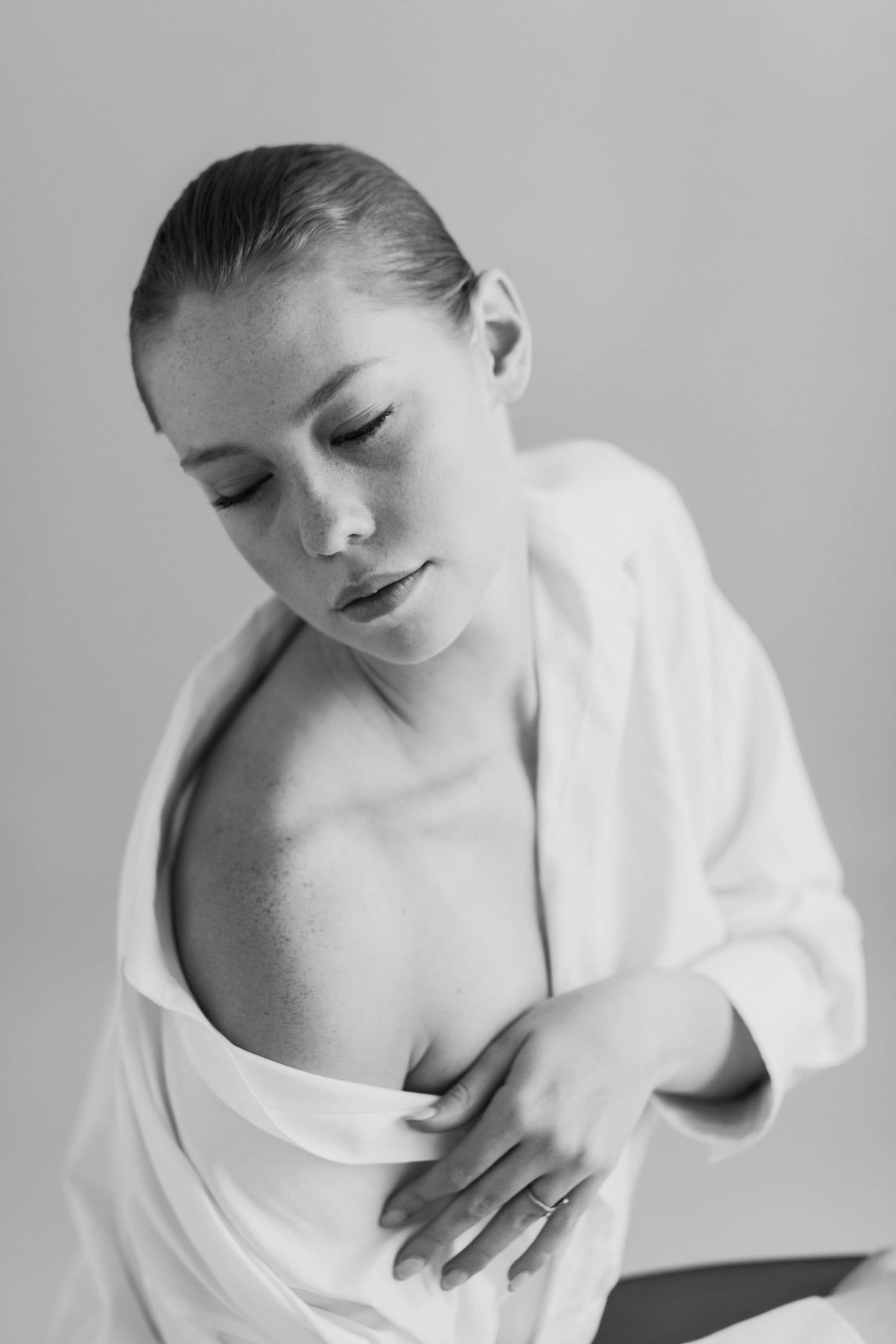 Studio portrait of a high fashion model leaning into the light.