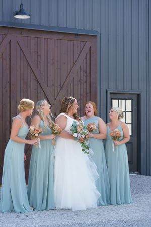Laughing bride with her bridesmaids during portraits