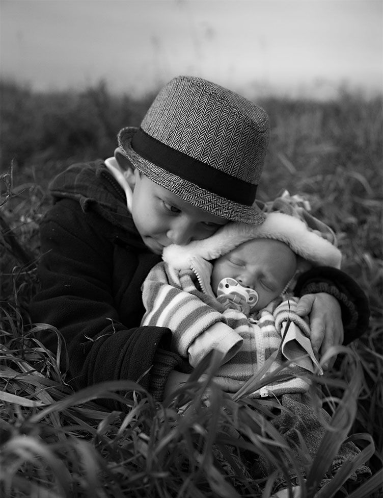 baby and young child together