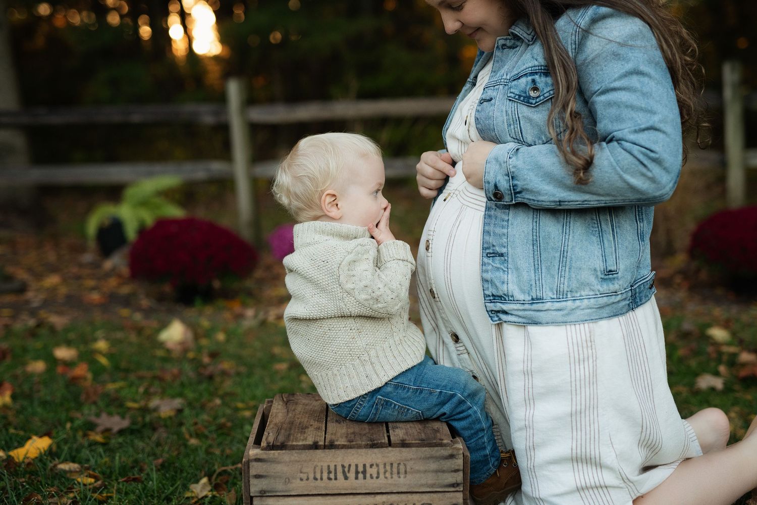 mom and son maternity picture touching baby belly