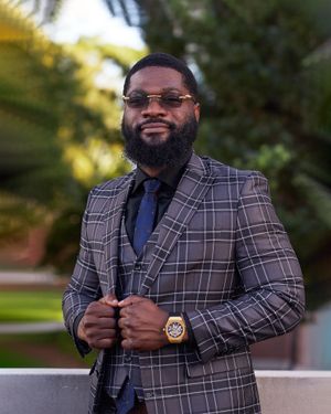 Stylish portrait of well-dressed person in plaid suit with sunglasses.