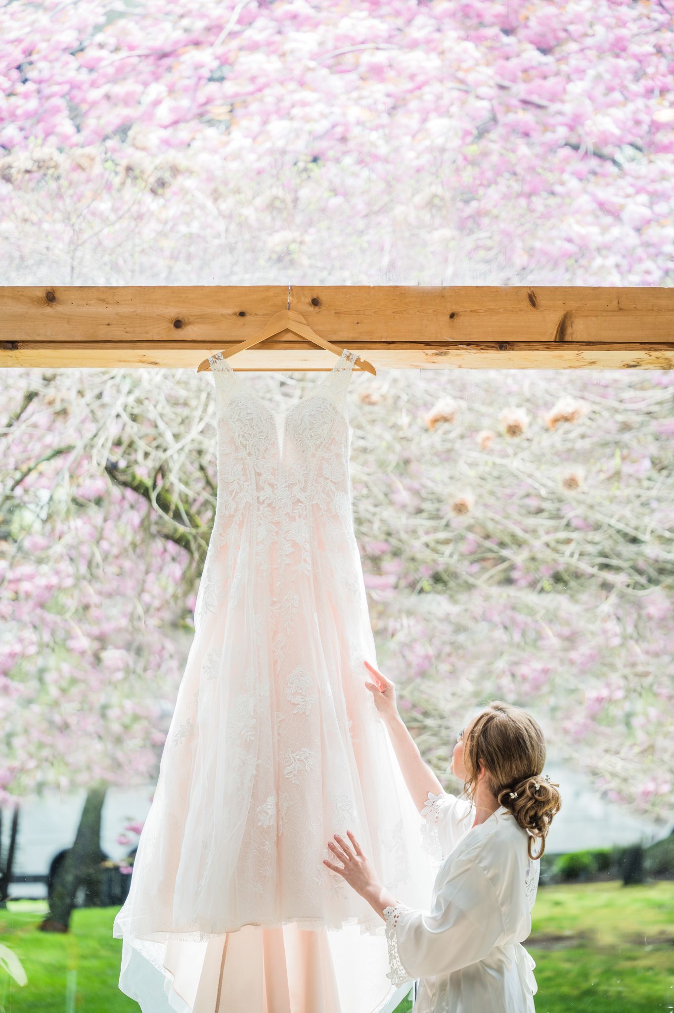 Bride admiring her dress during getting ready.