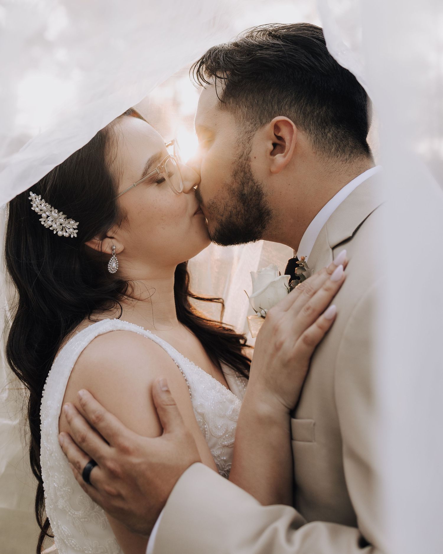 An intimate moment captured between newlyweds during their outdoor wedding celebration.