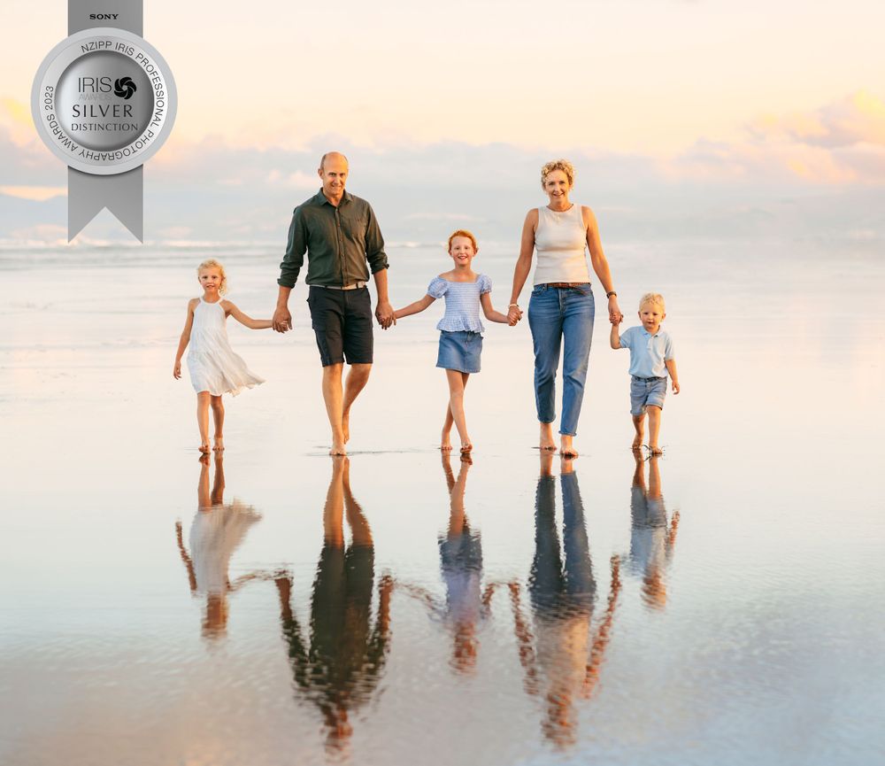 Silver award winning photo of family of 5 walking on beach at sunset with reflection on the sand in Christchurch NZ