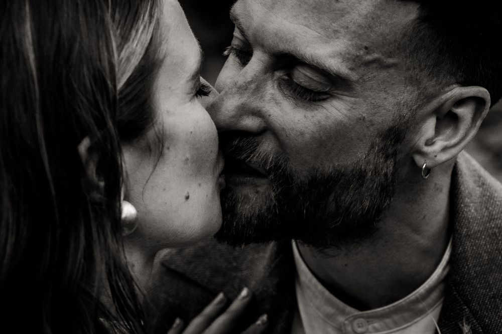 An intimate black and white portrait capturing a romantic moment between newlyweds.