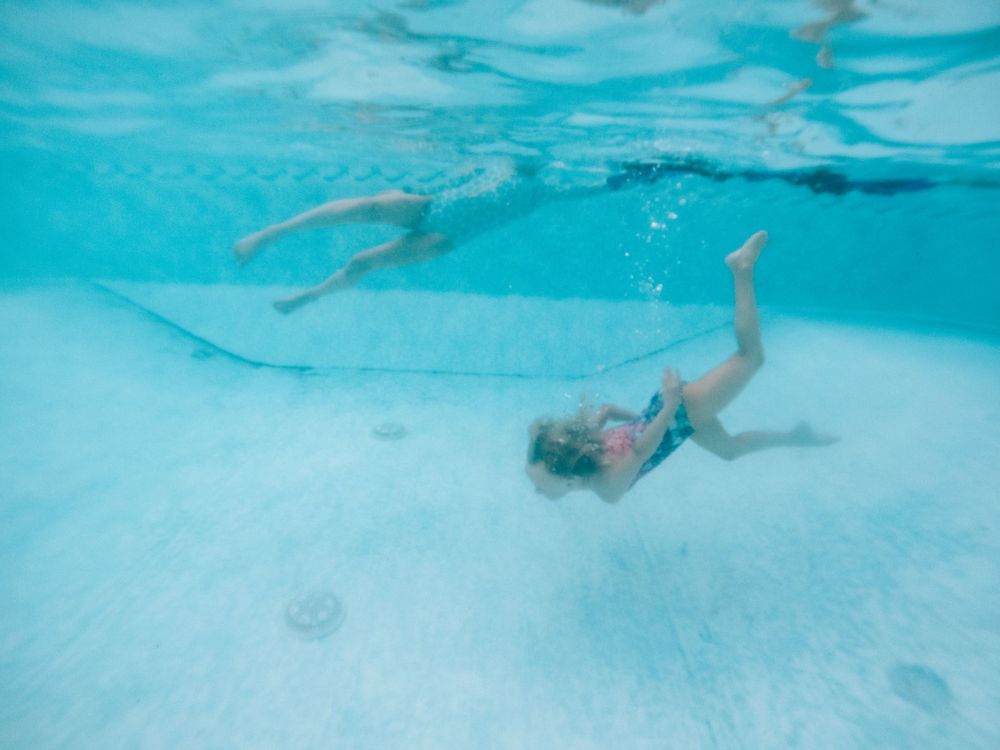 girls swimming under water at sandbridge beach vacation home in virginia
