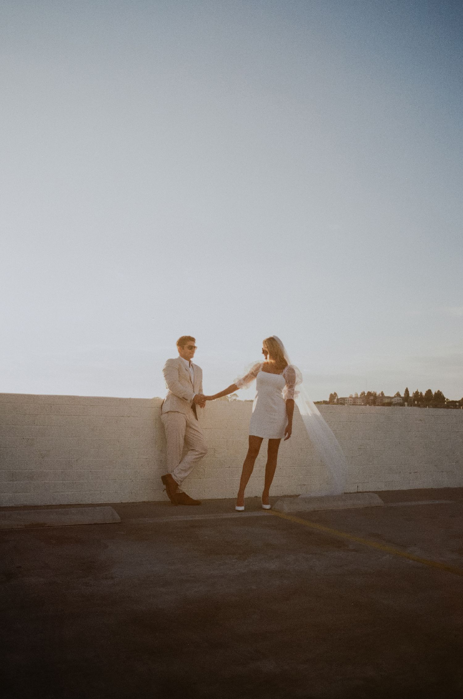 35mm film photo of fun bridal themed engagement shoot on roof of parking structure in Lido Marina, Newport beach