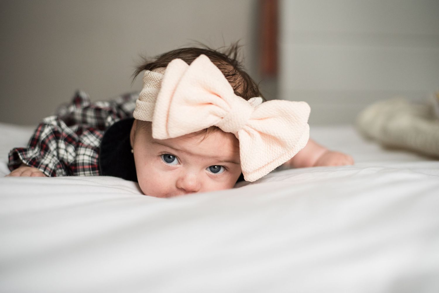 A little baby with a big pink bow.