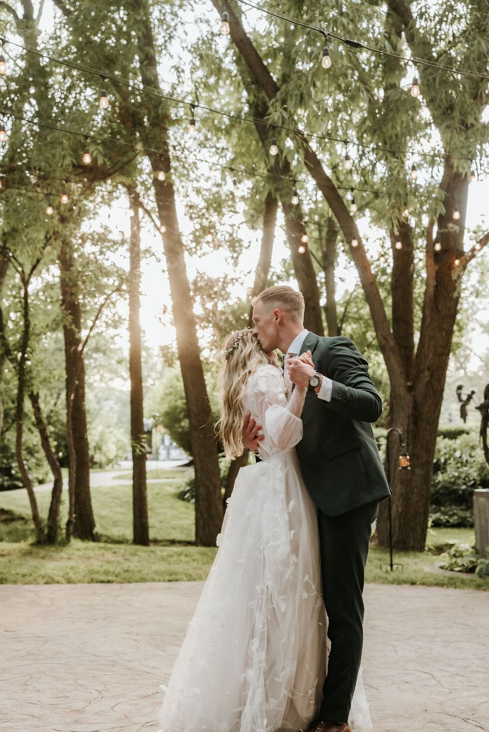 Utah newlyweds share intimate moments under tree canopy in romantic outdoor setting.