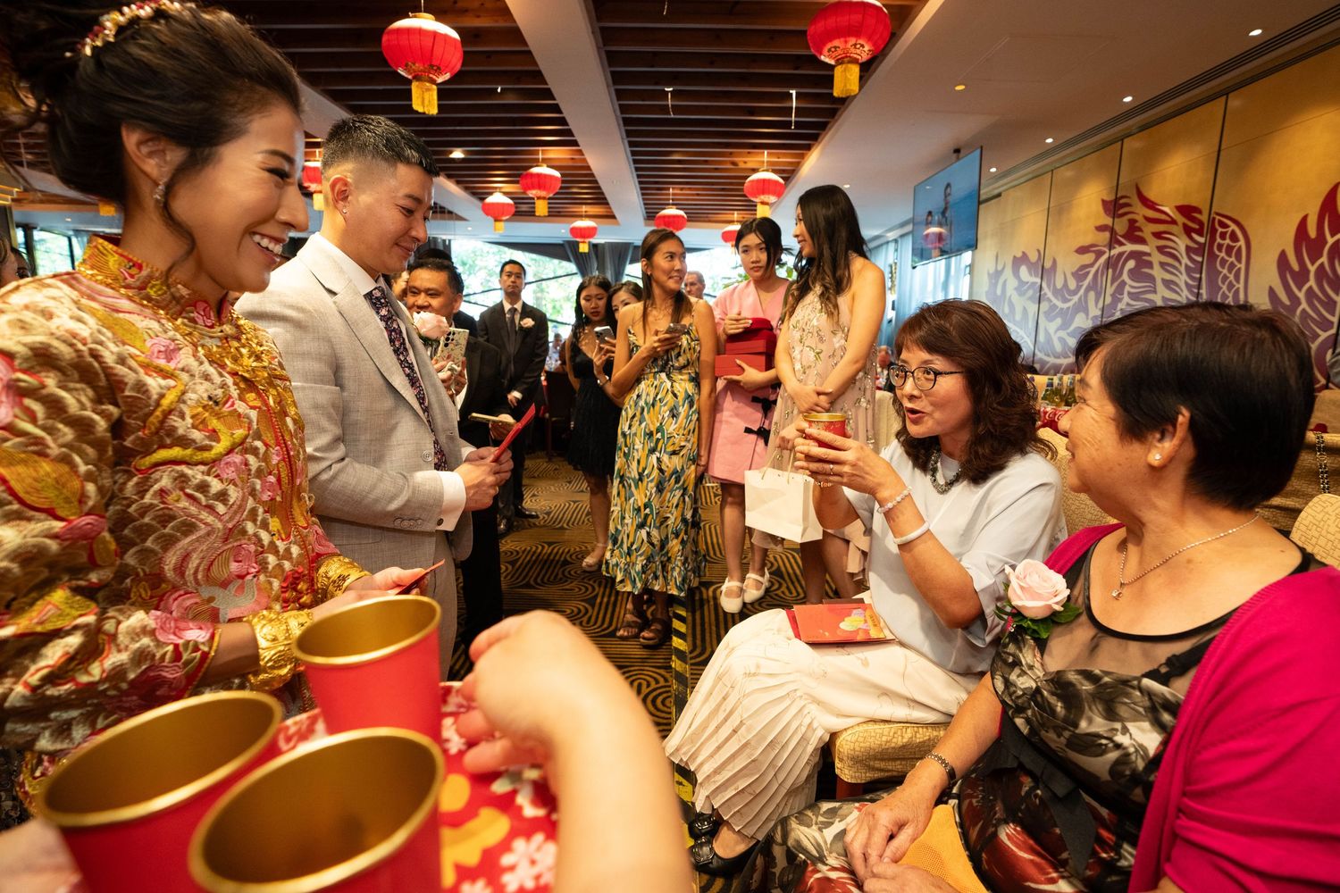 A traditional tea ceremony gathering with red lanterns and festive decorations.