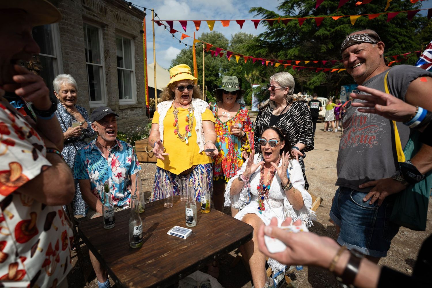 Outdoor party celebration with colorful bunting flags and festive atmosphere.