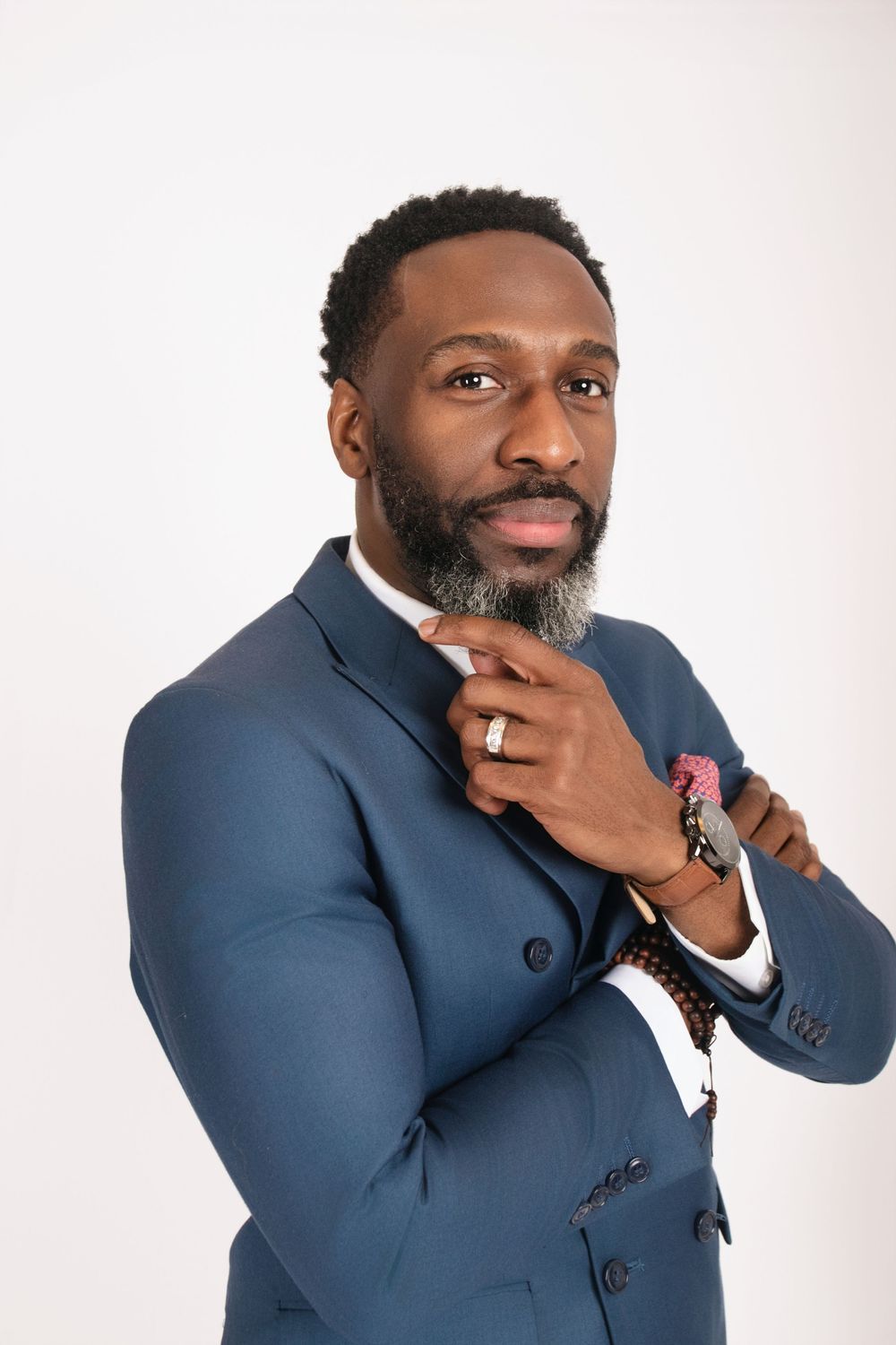Professional portrait series showing a person in a blue suit jacket posing thoughtfully against white background.