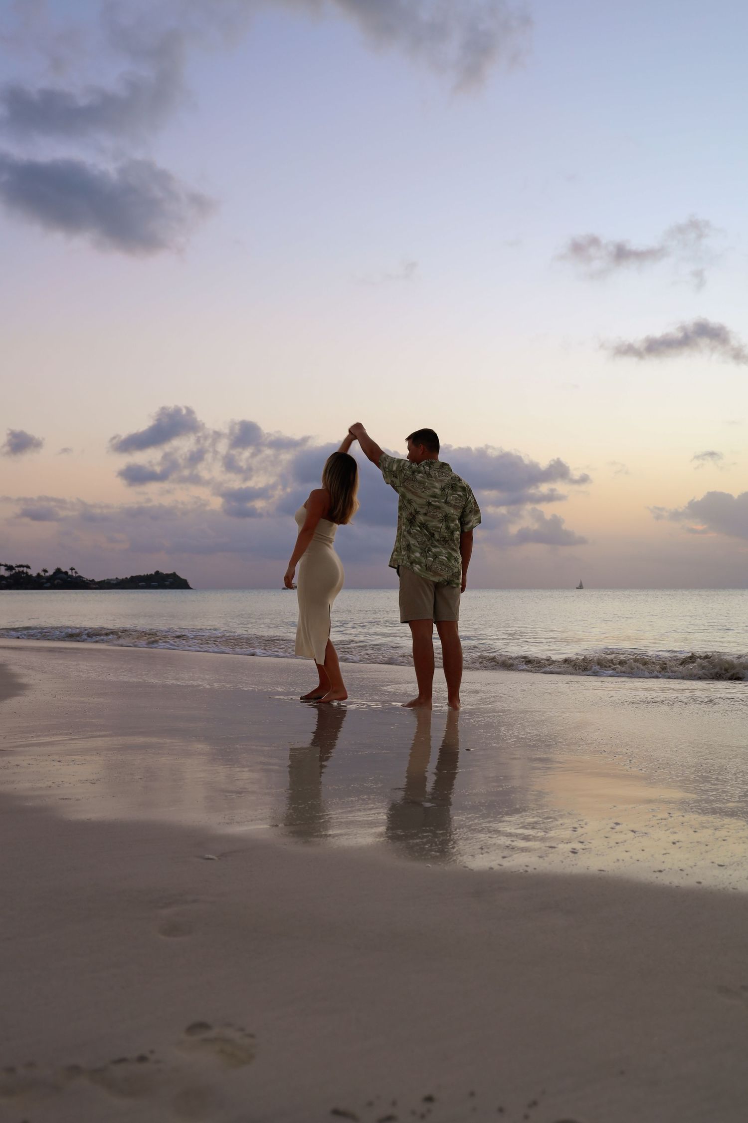 couple dancing on beach at sunset