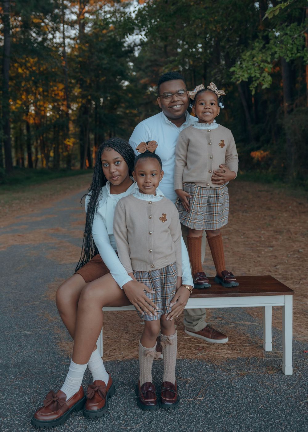 Happy family smiling together during a relaxed outdoor family photography session in North Carolina.