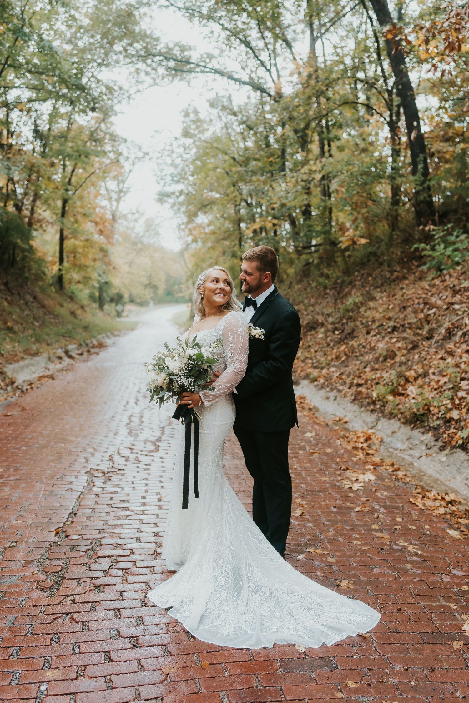 Bride smiling over her shoulder wearing her wedding dress and veil