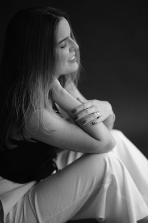 Intimate black and white portrait showing emotional expression in white flowing fabric.