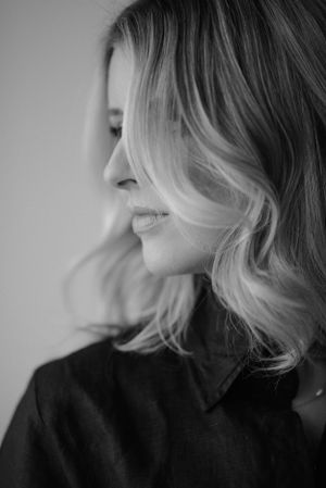 Side profile portrait showing soft waves in hair and natural lighting.