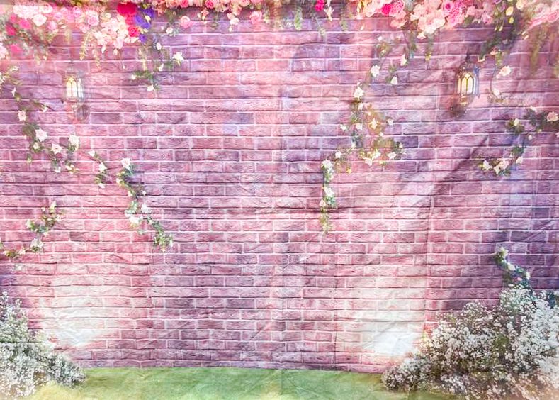 Pink brick wall backdrop with floral decorations and dreamy lighting effects.