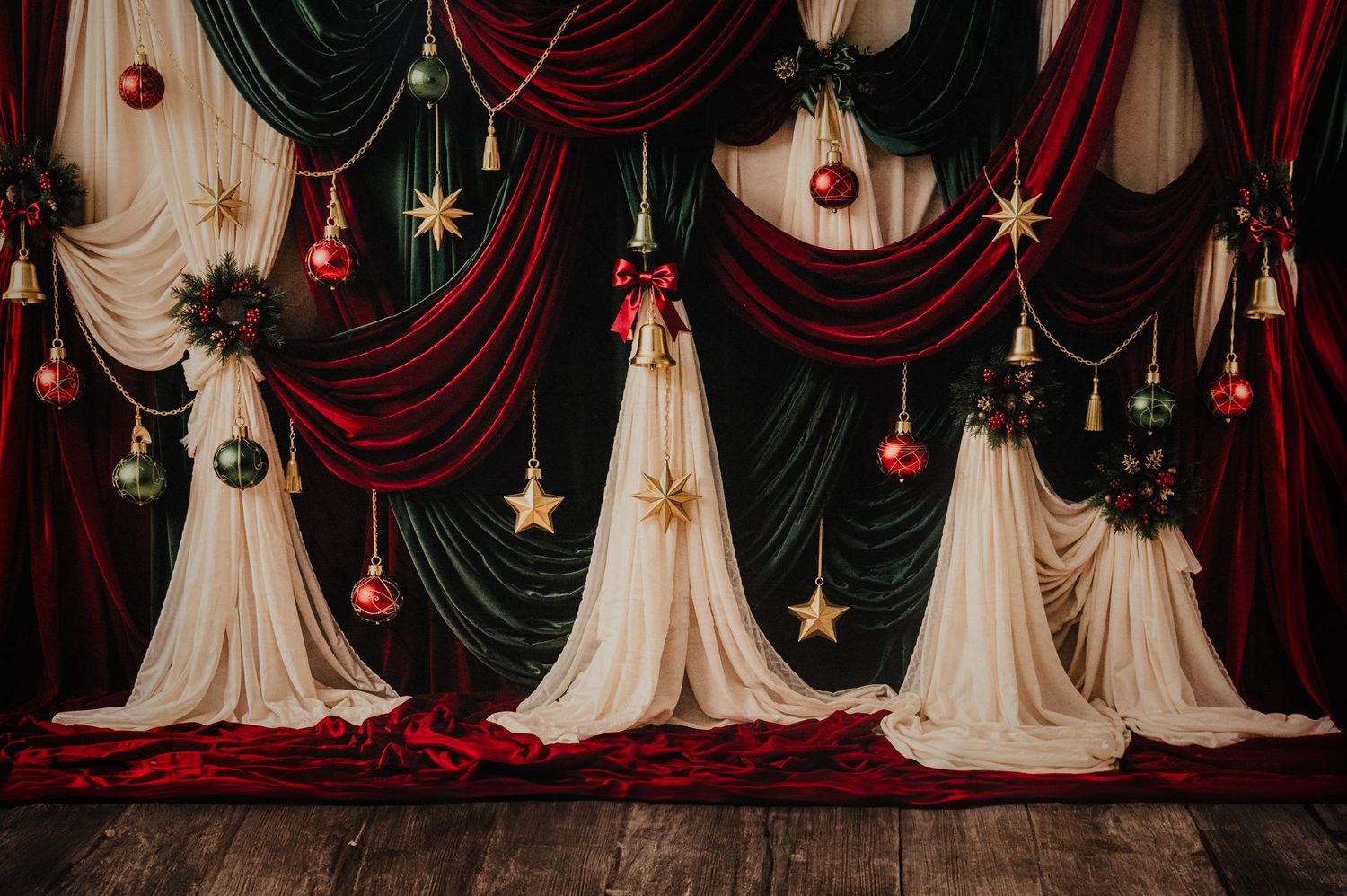 Festive Christmas backdrop with red and green velvet drapes, gold star ornaments, and elegant cream fabric trees on wooden floor.