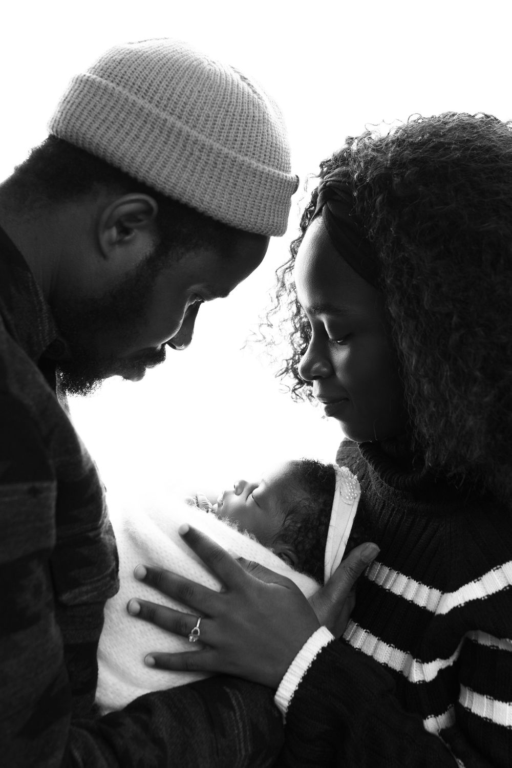 A black and white photo sequence showing two people in close intimate poses wearing winter hats.