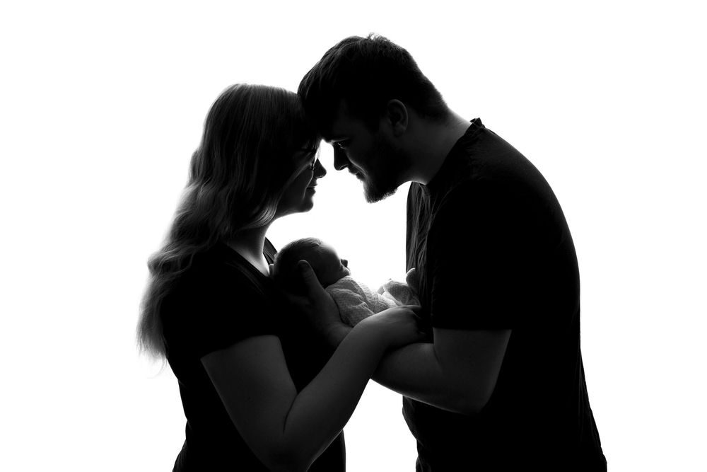 A series of black and white silhouettes showing people dancing together in romantic poses.