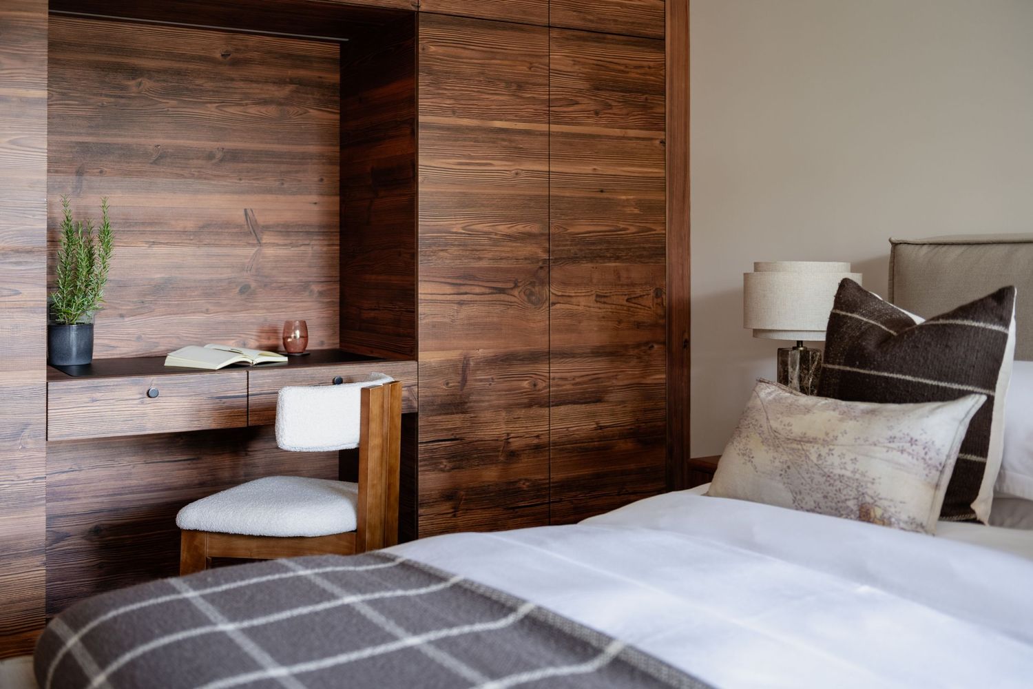 Design by Irma bedroom with wooden cupboards in Crans Montana