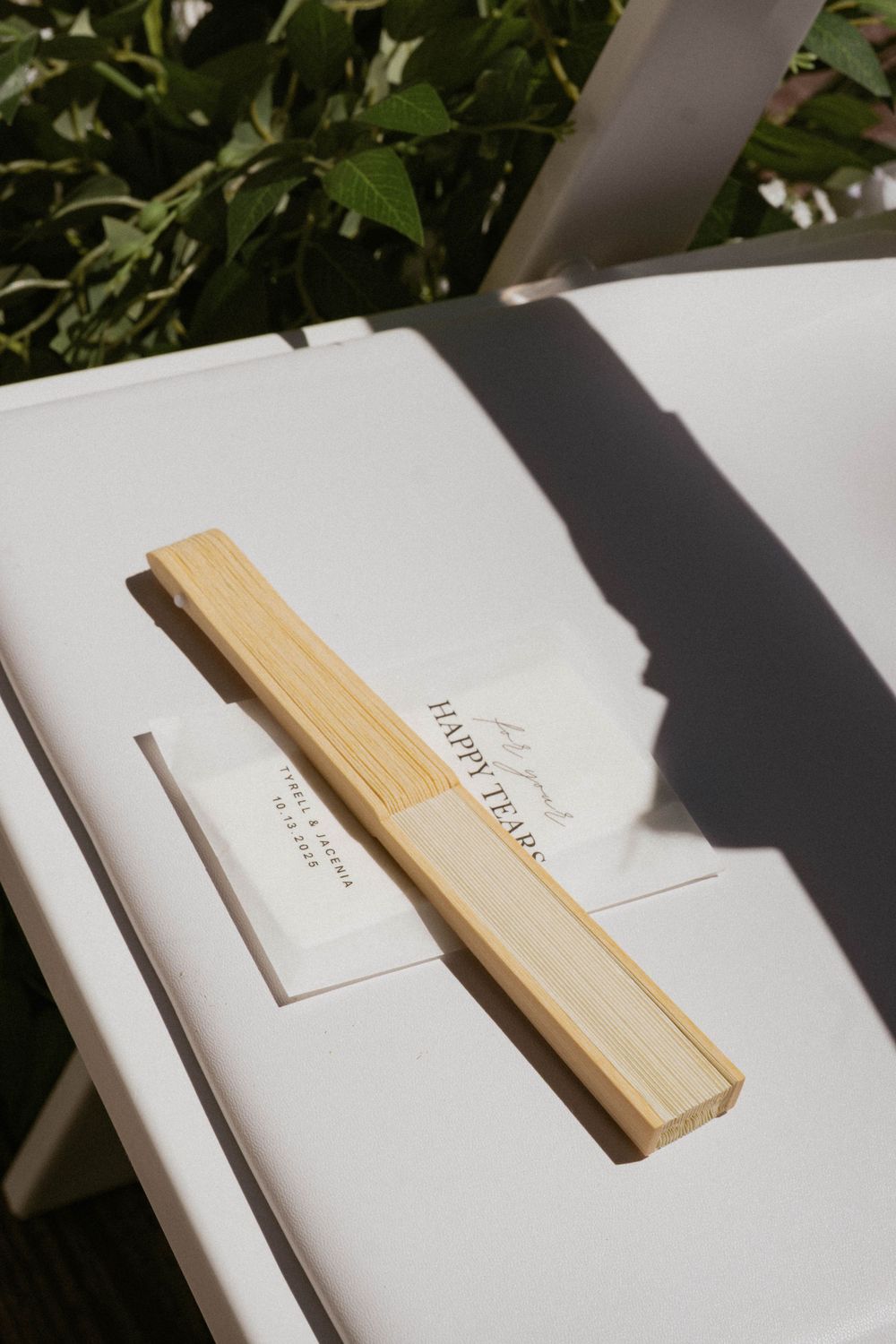White wedding invitations and envelopes arranged in a minimalist style with natural lighting.