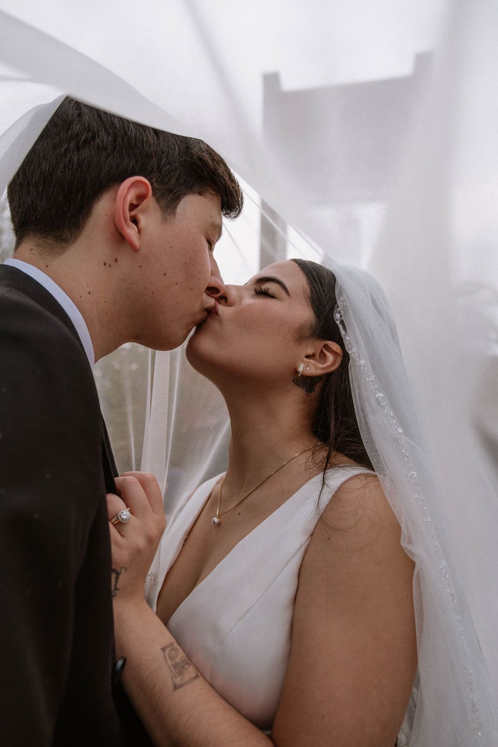 Intimate wedding portrait showing tender moment between newlyweds.