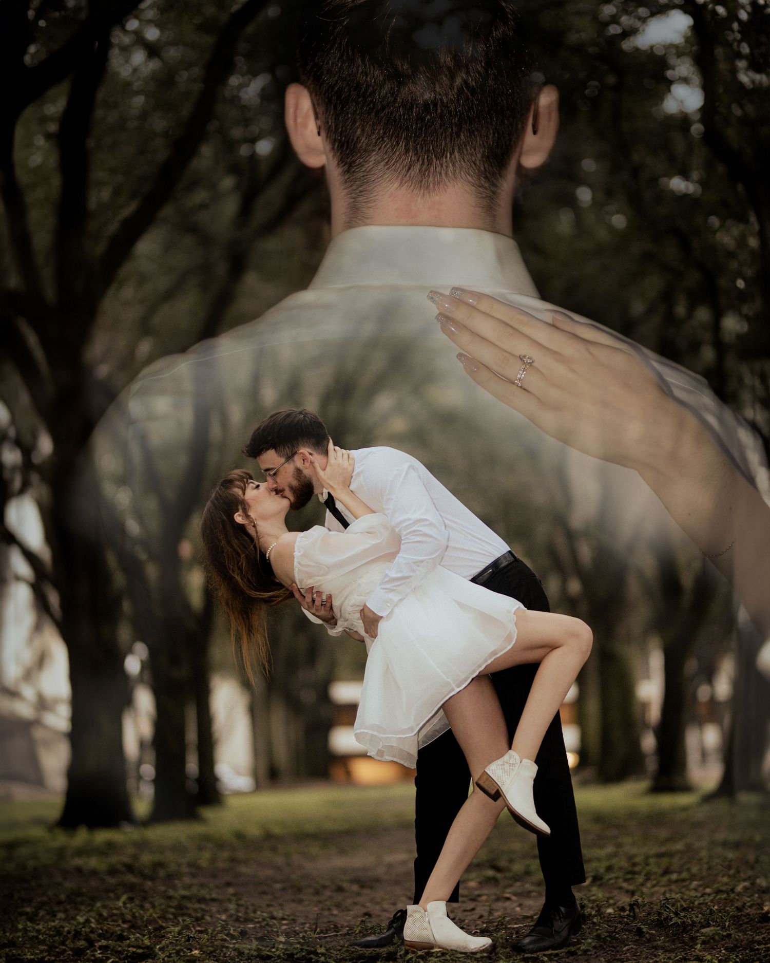 Couple performs dramatic dance dip pose in a park setting with trees.
