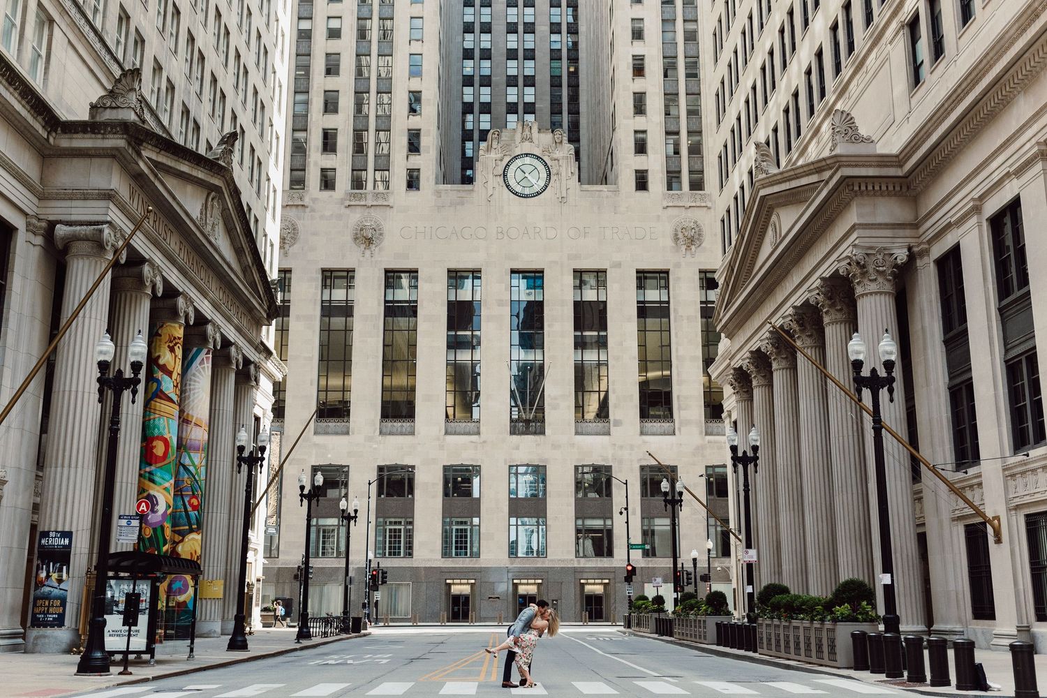 Panoramic view of historic building exterior with classical columns and modern skyscrapers.