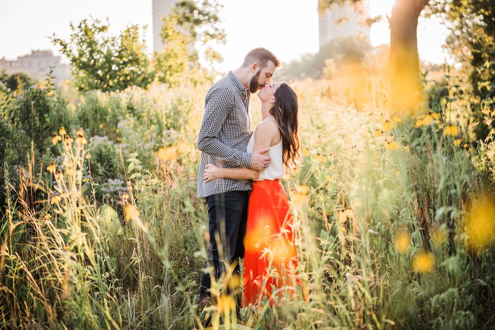 Couple kissing during their engagement session in a garden in Chicago.