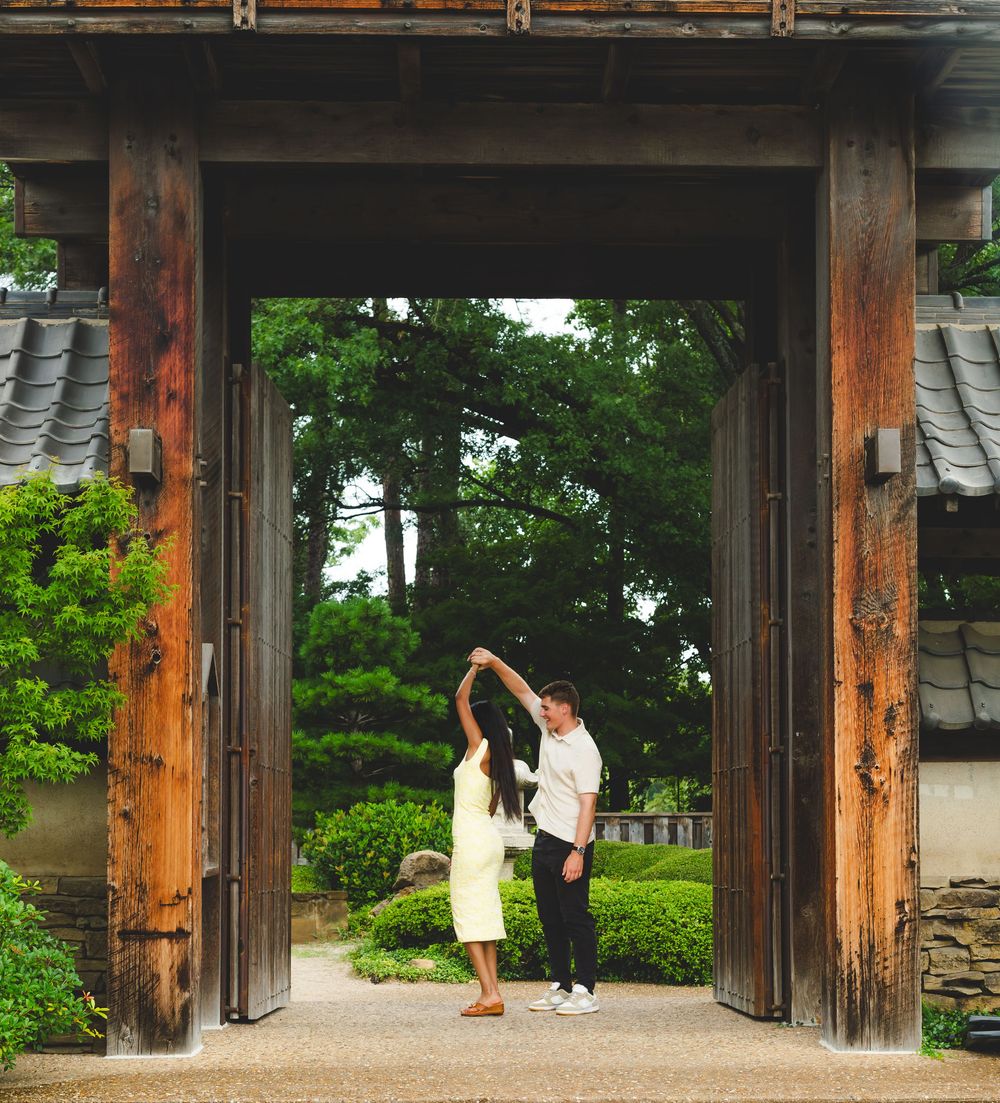 Traditional wooden temple gate entrance with rustic posts and beams in a Japanese garden.