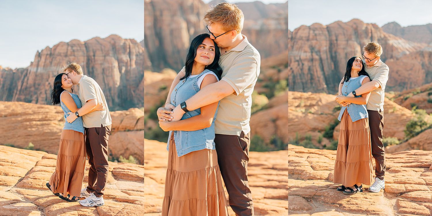 A couple embraces on red rock formations in Arches National Park during sunset with dramatic desert cliffs in background.