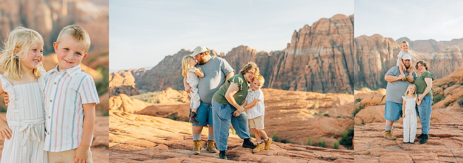 A couple in casual attire embraces while standing on red rock formations in a desert landscape at sunset.